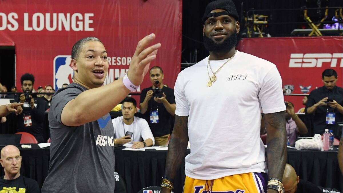 Tyronn Lue, then coach of the Cavaliers, and LeBron James chat during a Las Vegas Summer League game on July 15, 2018.
