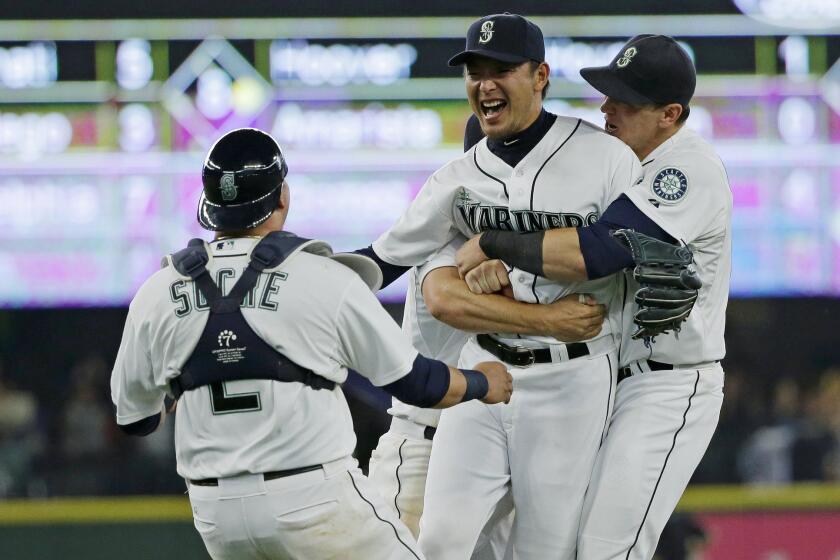 Mariners starting pitcher Hisashi Iwakuma, second from right, celebrates with catcher Jesus Sucre (2) and first baseman Logan Morrison, right, after Iwakuma threw a no-hitter against the Orioles in August.