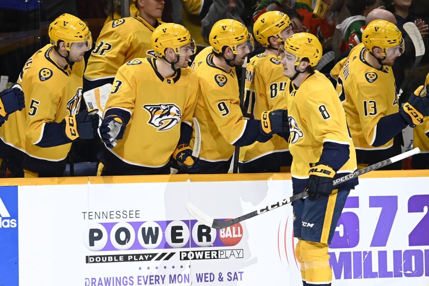 Nashville Predators center Cody Glass (8) is congratulated after his goal against the New Jersey Devils during the first period of an NHL hockey game Thursday, Jan. 26, 2023, in Nashville, Tenn. (AP Photo/Mark Zaleski)