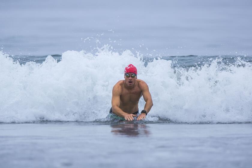 Joe McCauley swims in waters off Santa Monica Beach after getting help with his aquaphobia.