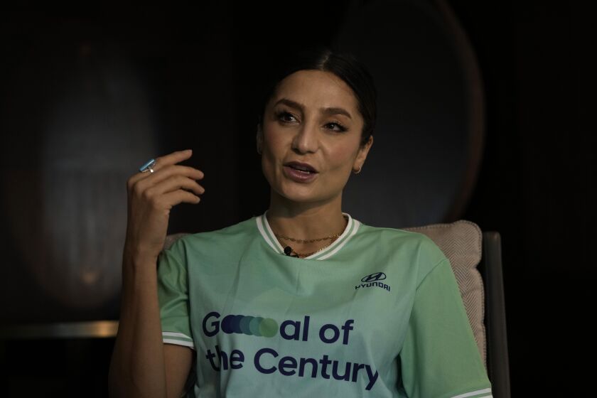 Nadia Nadim gestures as she speaks during an interview with The Associated Press in Doha, Qatar, Thursday, Dec. 1, 2022. Danish women's national team player Nadia Nadim was about to settle in for her job as a television commentator at the World Cup when she was shaken by tragic news: Her mother, who had helped the family flee the Taliban when Nadim was just a girl, had been hit by a car while rushing home to watch her daughter on TV. (AP Photo/Hassan Ammar)