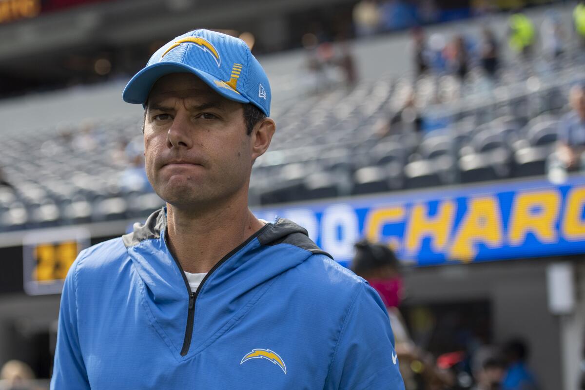 Chargers coach Brandon Staley stands on the field before a game.