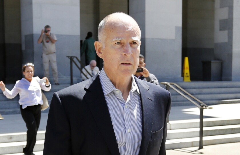 Gov. Jerry Brown attends a victim rights rally at the Capitol on Tuesday. He spoke with reporters about the state budget afterward.