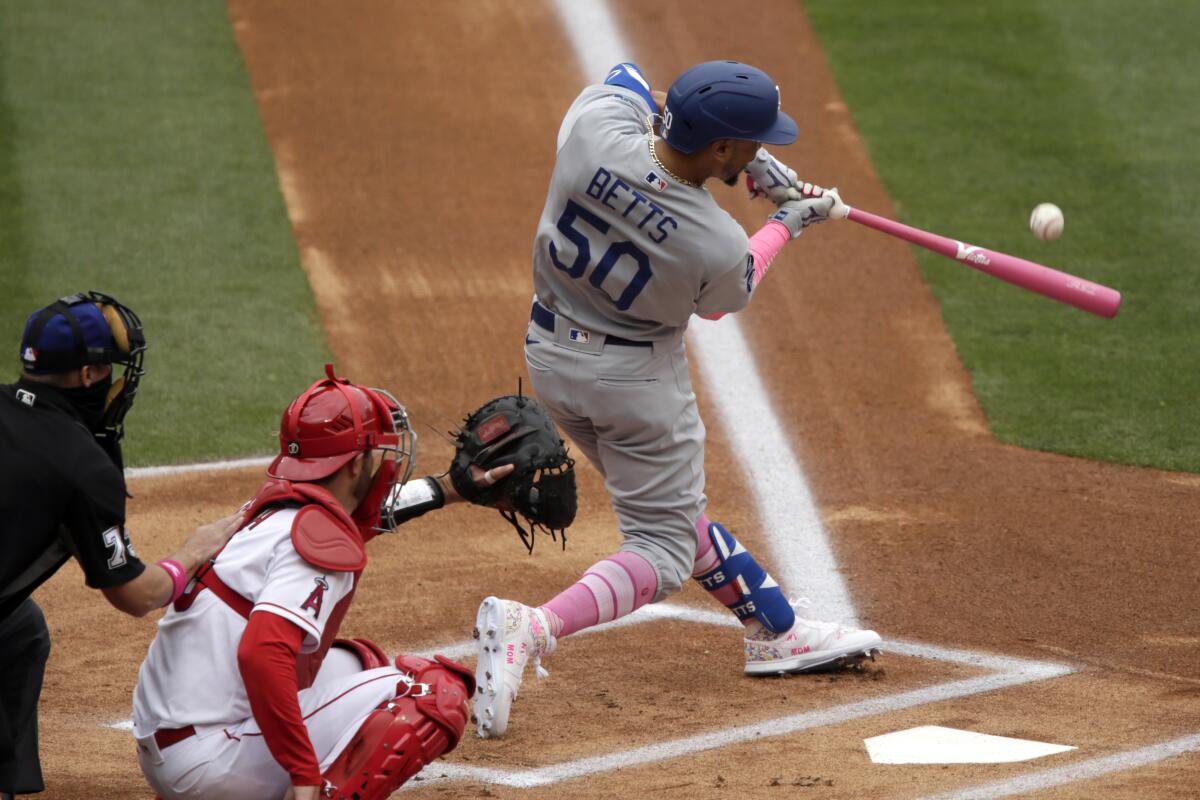 Los Angeles Dodgers' Mookie Betts, right, in action with Los Angeles Angels catcher Drew Butera.
