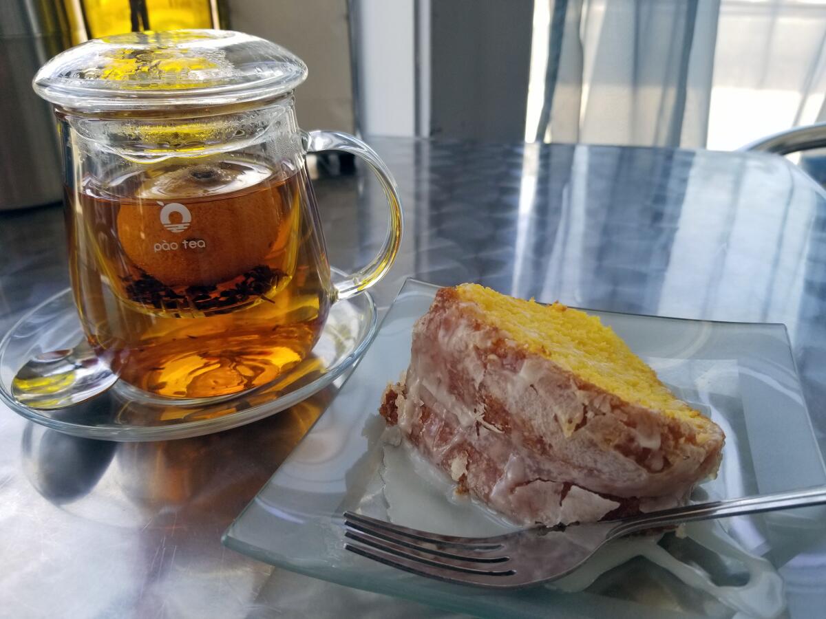 A glass of tea and a slice of cake at Mingles Tea Bar.