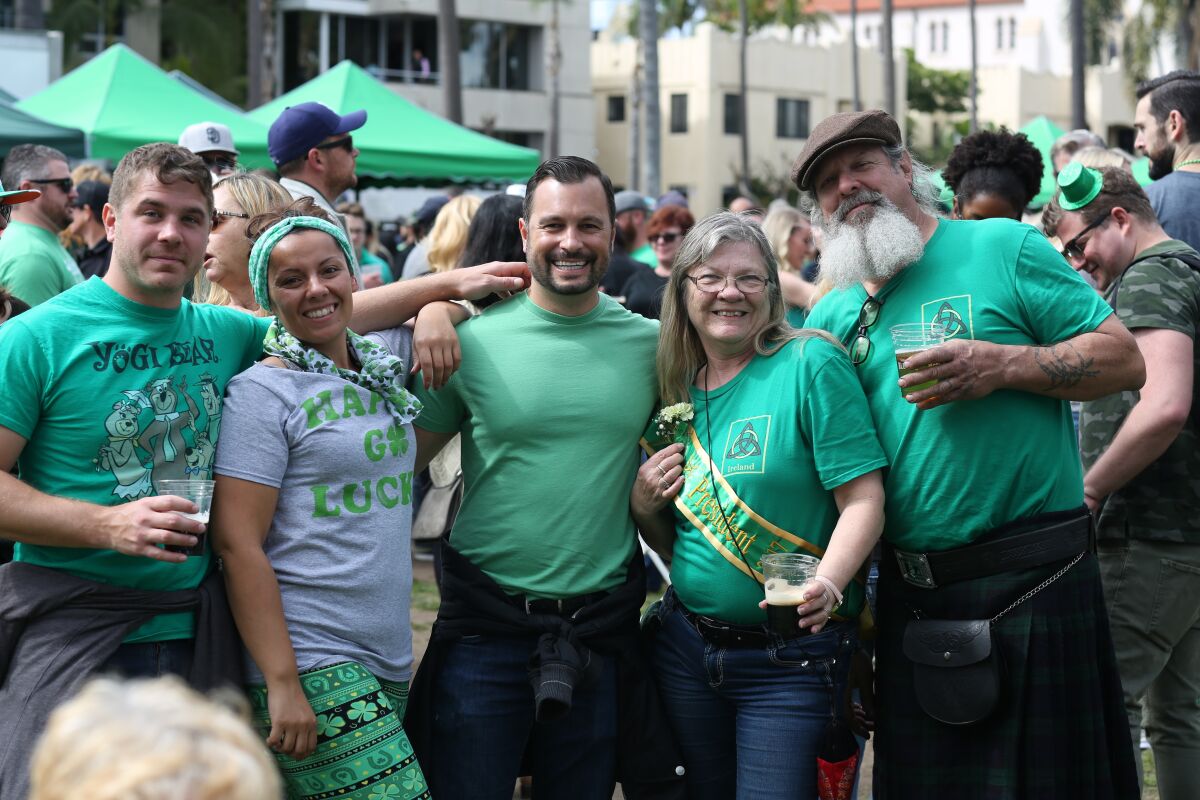 Folks in the crowd pose for a photo as they watch the St. Patrick's Day Parade in Balboa Park.