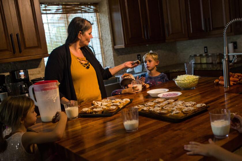 Loretta Miller, who lost six grandchildren and her daugher-in-law in the attack, provides snacks for some of her other grandchildren Wednesday afternoon in La Mora, Sonora state, Mexico. They are all members of the LeBarón family, dual Mexican and American citizens who have lived for decades in a breakaway Mormon community near the border.