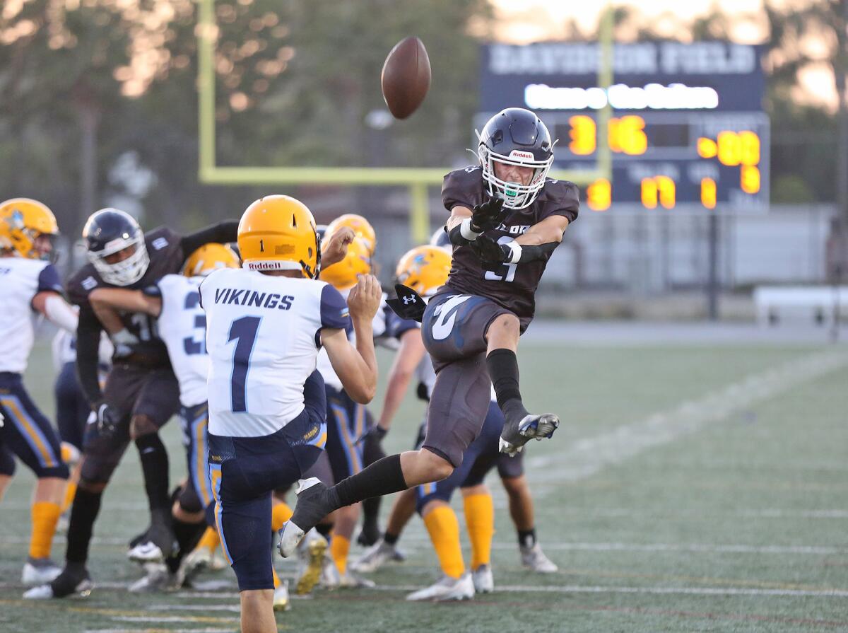 Defensive back Johnny Chaix (3) deflects a punt by Marina's Dylan Keidel in a nonleague football game on Thursday.