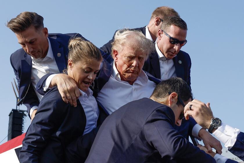 BUTLER, PENNSYLVANIA - JULY 13: Republican presidential candidate former President Donald Trump is rushed offstage by U.S. Secret Service agents after being grazed by a bullet during a rally on July 13, 2024 in Butler, Pennsylvania. Butler County district attorney Richard Goldinger said the shooter is dead after injuring former U.S. President Donald Trump, killing one audience member and injuring another in the shooting. (Photo by Anna Moneymaker/Getty Images)