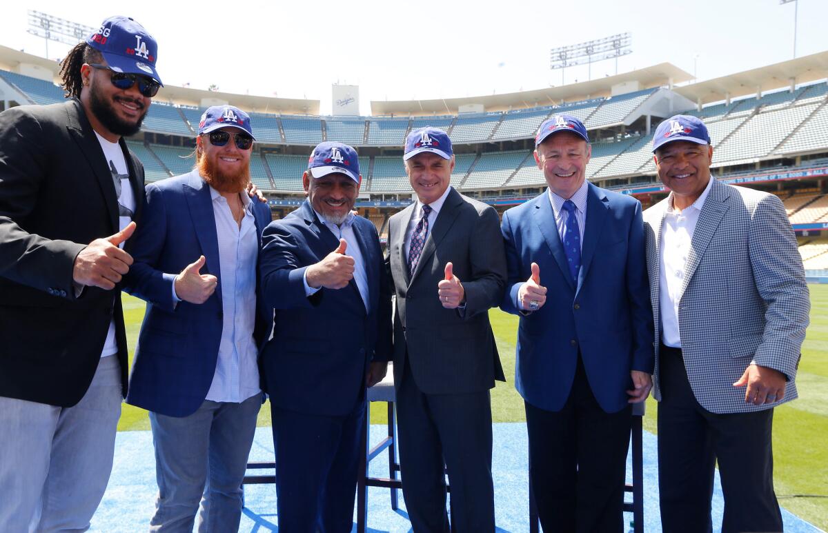 From left, Los Angeles Dodgers pitcher Kenley Jansen, third baseman Justin Turner, Los Angeles Councilman Gil Cedillo, Baseball Commissioner Rob Manfred, Los Angeles Dodgers President and CEO Stan Kasten, and manager Dave Roberts pose for a photo, after announcing that Dodger Stadium will host the All-Star Game in 2020 for the first time since 1980 at a news conference in Los Angeles Wednesday, April 11, 2018.