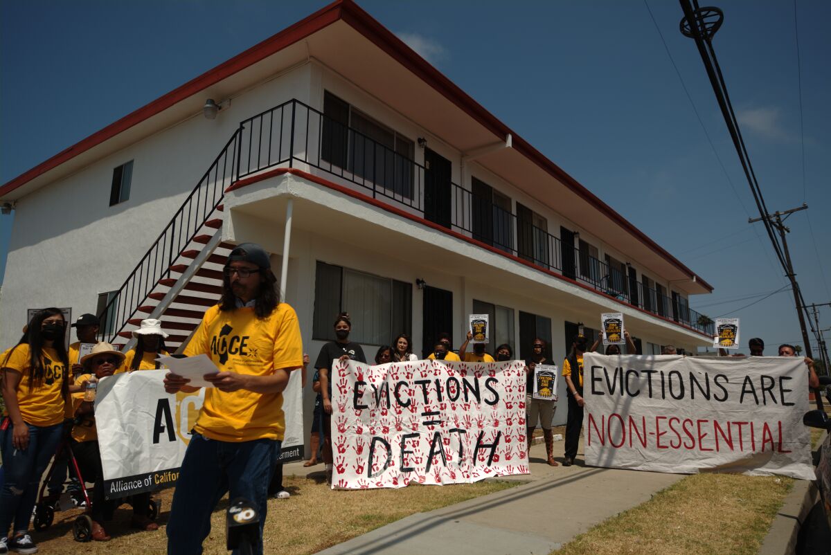 Tenants and tenants' rights advocates hold a rally against evictions on July 15 outside a Chula Vista apartment.