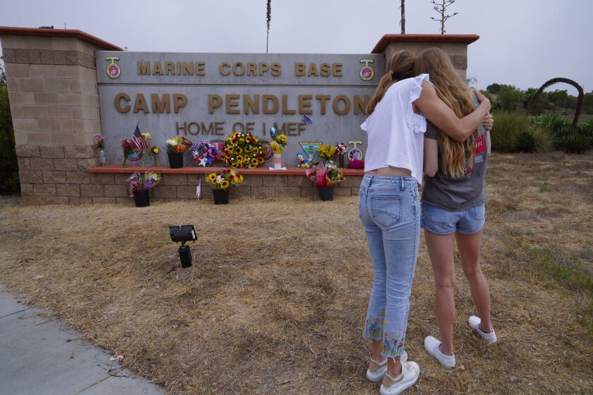 Ericka Beck comforted her daughter, Cara Steffens outside Camp Pendleton’s main gate in Oceanside.