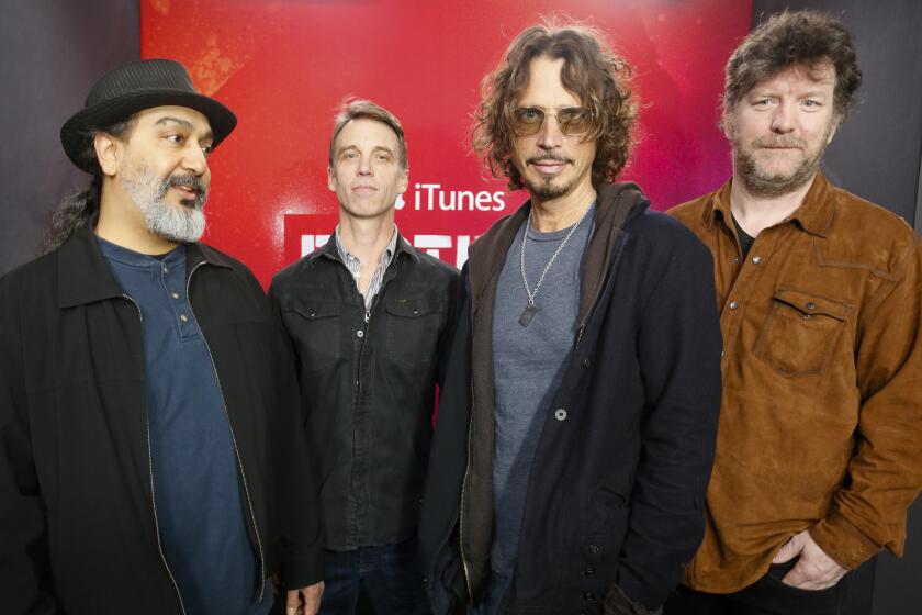 Soundgarden members Kim Thayil, Matt Cameron, Chris Cornell and Ben Shepherd standing in a line, posing for photo  