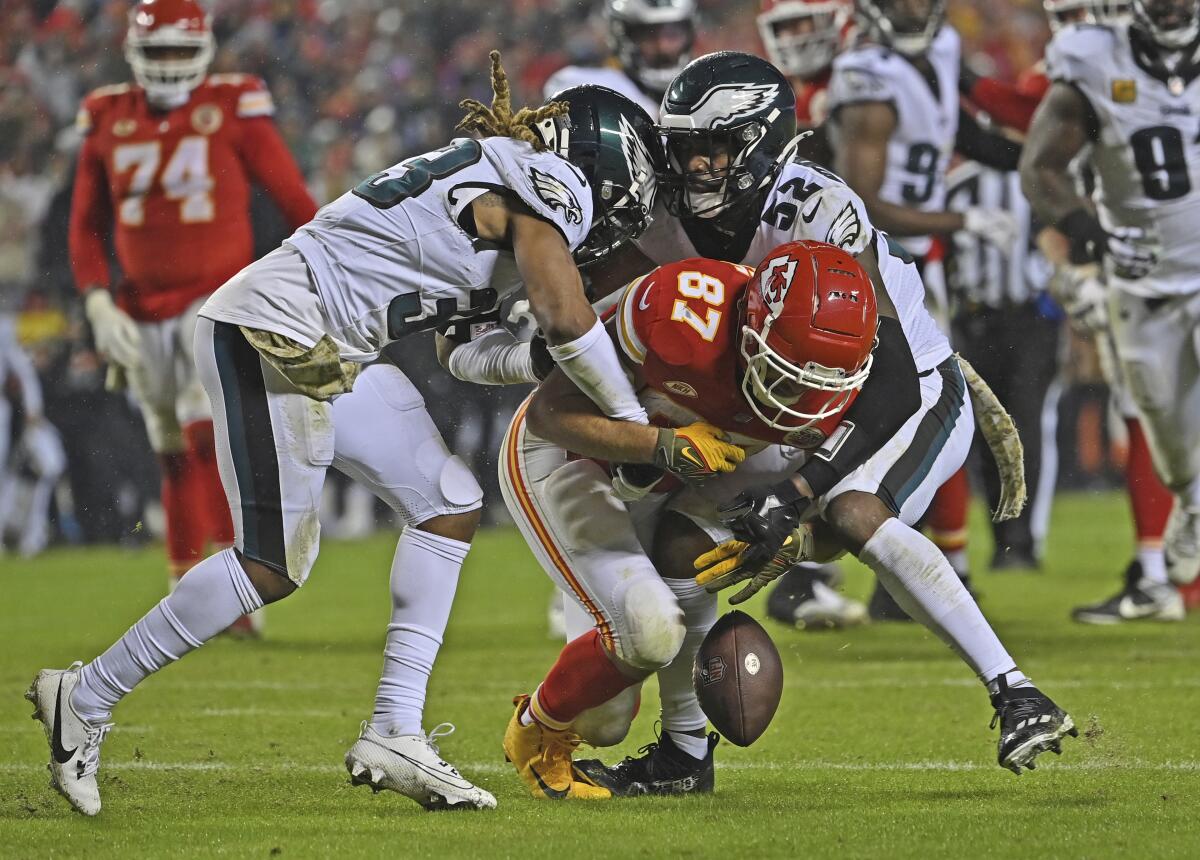 Chiefs tight end Travis Kelce fumbles the ball after getting hit by Eagles Bradley Roby and Zach Cunningham 