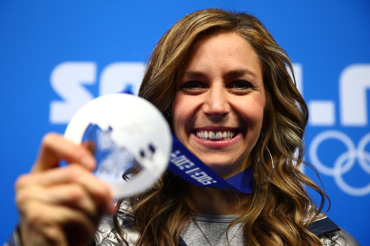 U.S. silver medalist Noelle Pikus-Pace celebrates during the medal ceremony for the Women's skeleton on Saturday, Day 8 of the Sochi 2014 Winter Olympics at Medals Plaza.