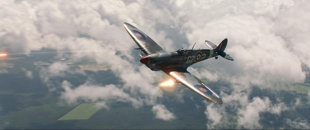 A World War II fighter plane soars above the clouds.