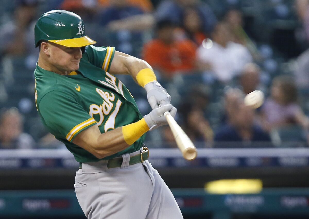 FILE -O akland Athletics' Matt Chapman hits a two-run home run against the Detroit Tigers during the third inning of a baseball game Tuesday, Aug. 31, 2021, in Detroit. All-Star third baseman Matt Chapman was acquired by the Toronto Blue Jays from the payroll-shredding Oakland Athletics for four players on Wednesday, March 16, 2022. (AP Photo/Duane Burleson, File)
