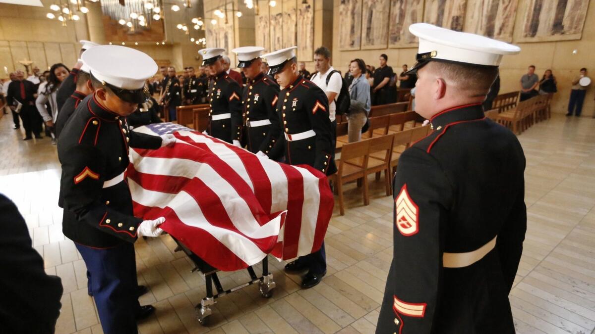 Marine pallbearers prepare a flag-draped coffin during a funeral service for Lance Cpl. Carlos Segovia-Lopez at the Cathedral of Our Lady of the Angels in 2016. The 19-year-old Marine from Camp Pendleton was shot and killed Sept. 19, 2016, in South Los Angeles.