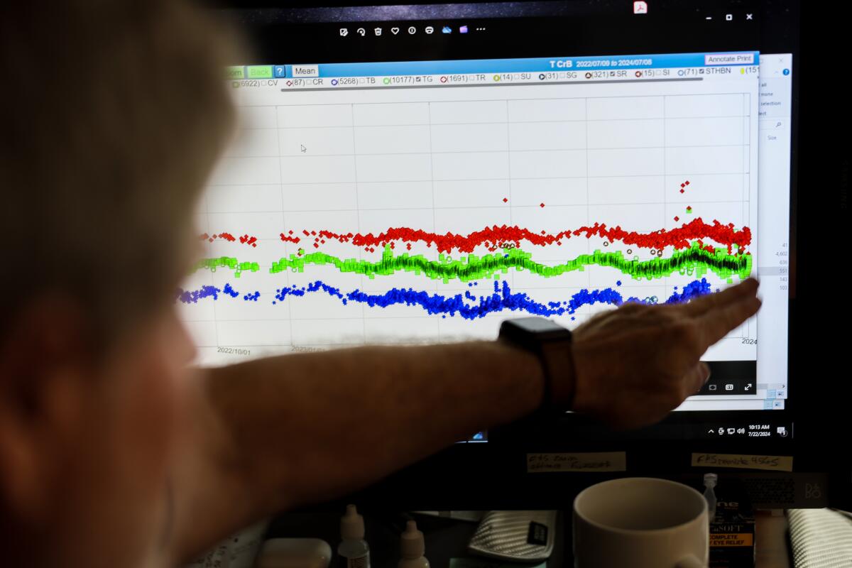 Bob Stephens points to a computer screen with data from the Blaze Star.