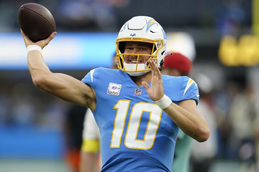 Los Angeles Chargers quarterback Justin Herbert (10) warms up before an NFL football game.