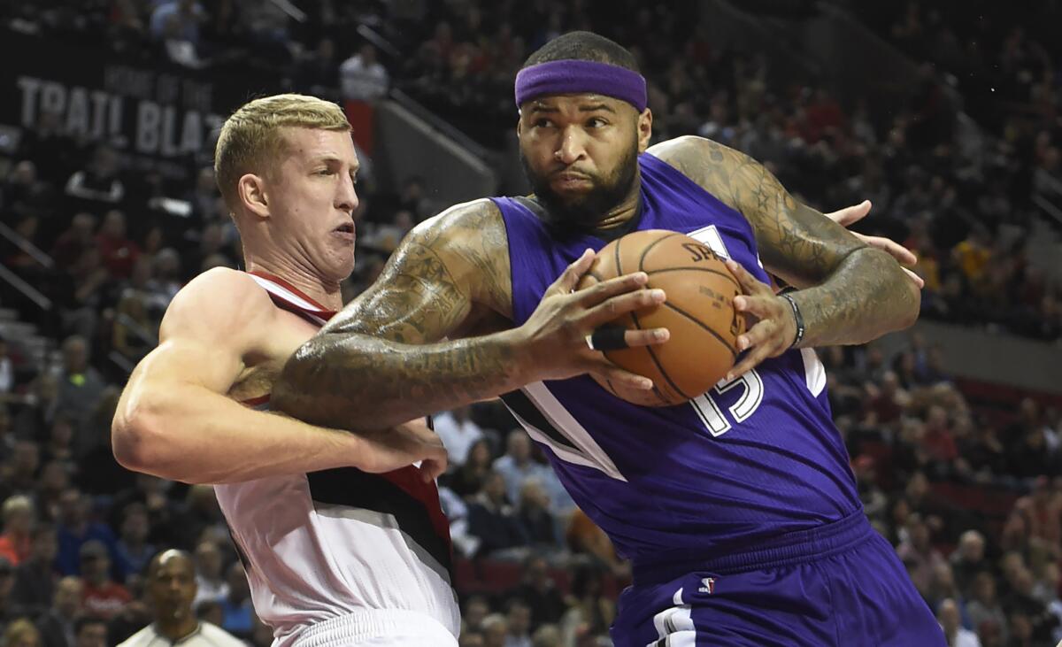Kings center DeMarcus Cousins drives to the basket on Trail Blazers center Mason Plumlee during a game on Jan. 26.