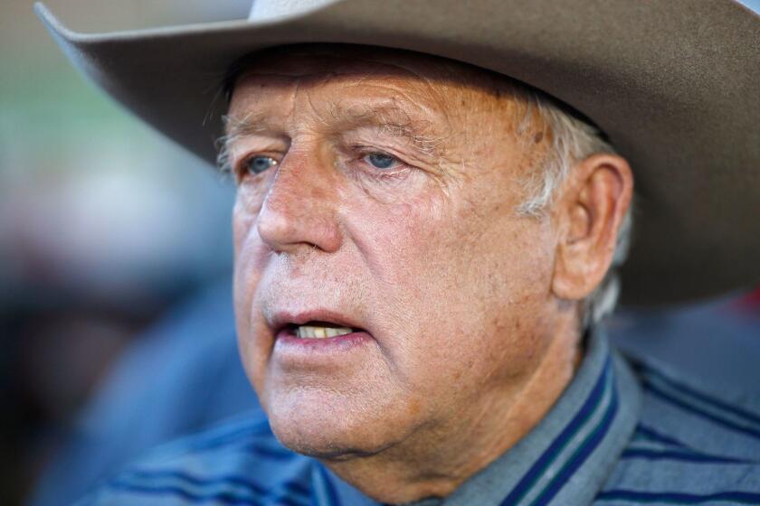 FILE - In this April 11, 2015, file photo, Nevada rancher Cliven Bundy speaks with supporters at an event in Bunkerville, Nev. Twice federal prosecutors in Las Vegas have failed to win full convictions of men who had guns during an April 2014 armed standoff with government agents trying to round up cattle belonging to Nevada rancher Cliven Bundy. Nevertheless, they're now moving to the main event, with openings expected Tuesday, Nov. 7 for a trial of the 71-year-old family patriarch and states' rights figure, his two eldest sons and one other co-defendant accused of leading a self-styled militia in an uprising against government authority.(AP Photo/John Locher, File)