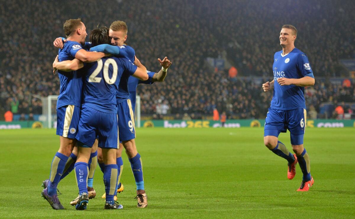 Leicester City's Japanese footballer Shinji Okazaki (2nd L) celebrates with team-mates after scoring his team's first goal during the English Premier League football match between Leicester City and Newcastle at King Power Stadium in Leicester, central England on March 14, 2016. / AFP PHOTO / PAUL ELLIS / RESTRICTED TO EDITORIAL USE. No use with unauthorized audio, video, data, fixture lists, club/league logos or 'live' services. Online in-match use limited to 75 images, no video emulation. No use in betting, games or single club/league/player publications. / PAUL ELLIS/AFP/Getty Images ** OUTS - ELSENT, FPG, CM - OUTS * NM, PH, VA if sourced by CT, LA or MoD **