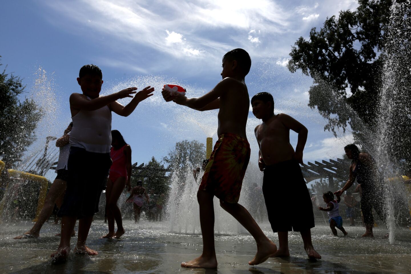 Kids cool off in the spray pool at Fullerton's Lemon Park.