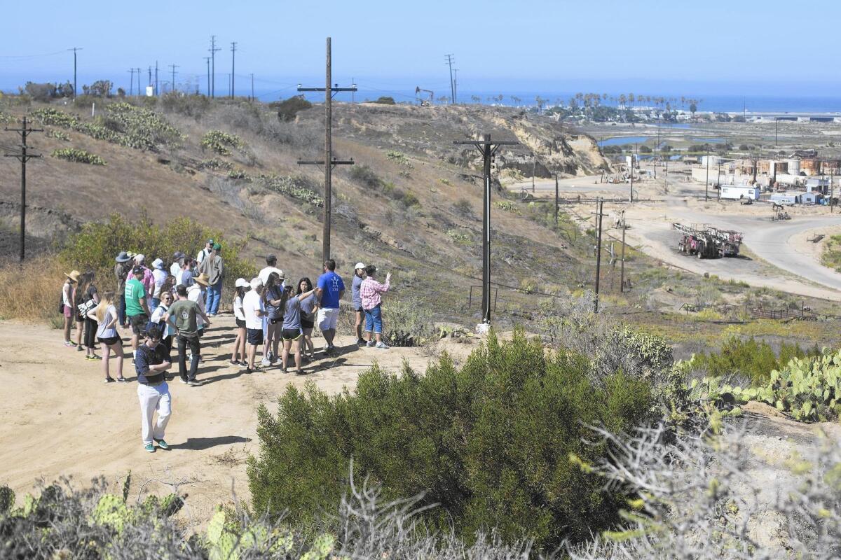 Visitors take a tour of Banning Ranch in July. The California Supreme Court is scheduled to hear arguments Wednesday in a lawsuit challenging the Newport Beach City Council’s approval in 2012 of a large residential and commercial development for the land.