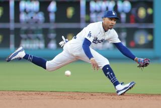 LOS ANGELES CALIFORNIA CALIFORNIA-Dodgers shortstop Mookie Betts can't make the play on a single by Rangers Nathaniel Lowe in the second inning at Dodgers Stadium Tuesday. (Wally Skalij/Los Angeles Times)