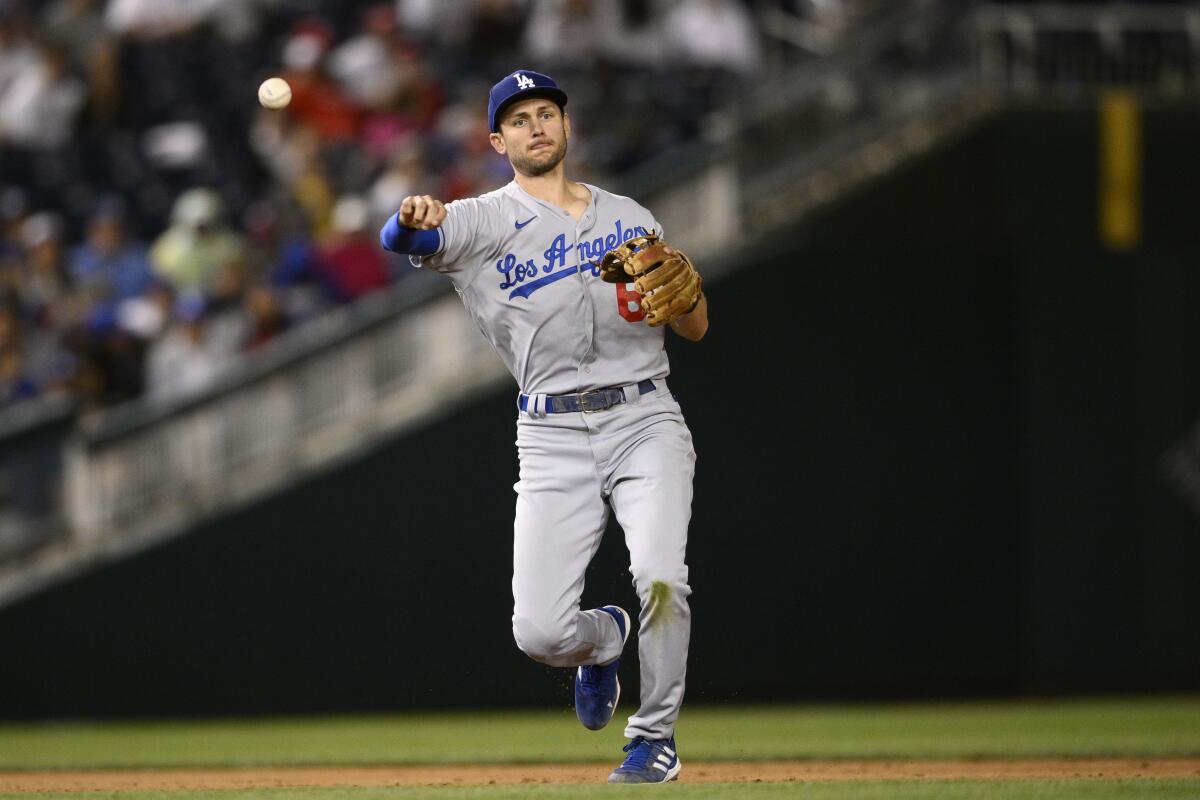 Dodgers shortstop Trea Turner throws to first base.
