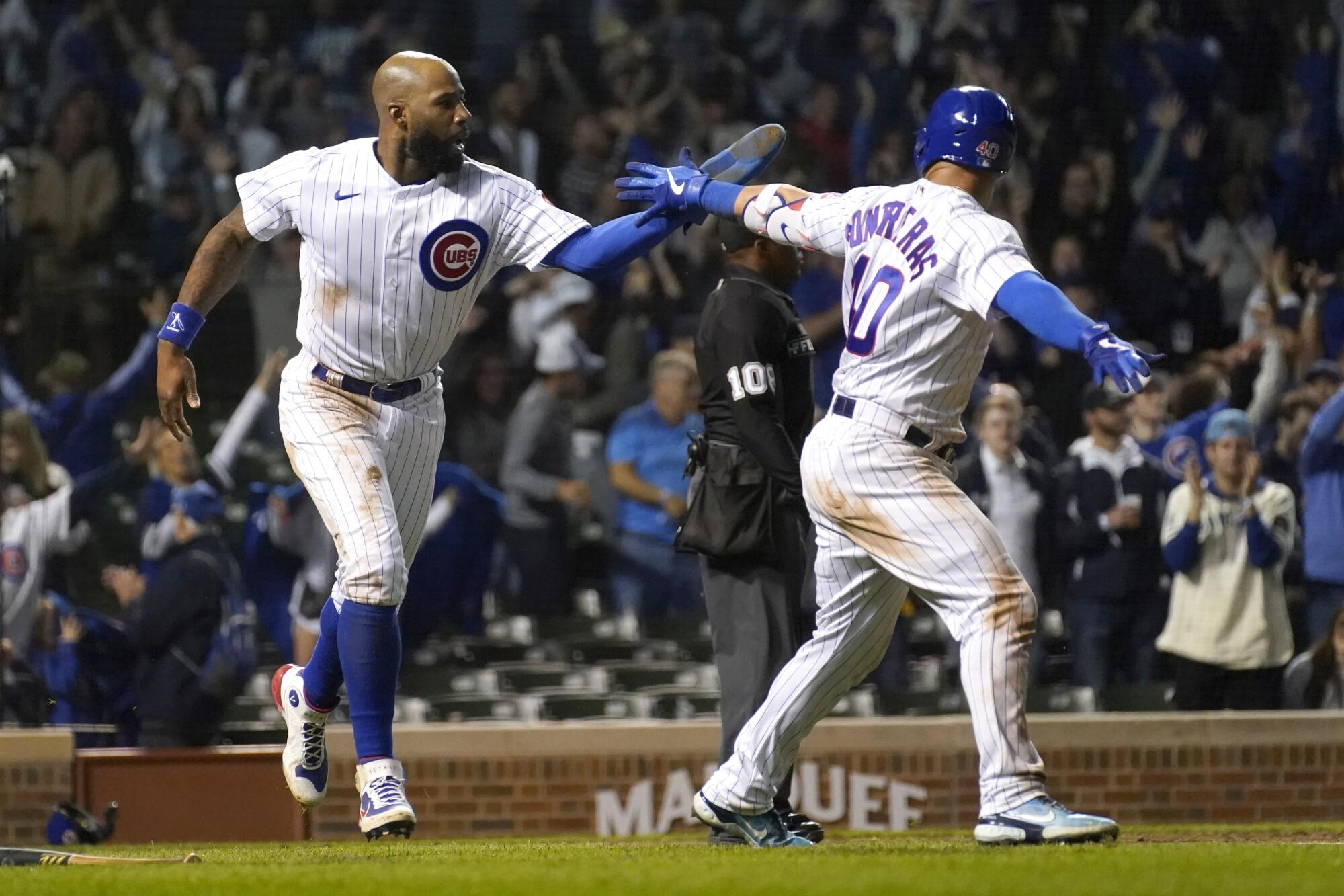 Chicago Cubs' Jason Heyward celebrates with Willson Contreras after Hayward scored the winning run.