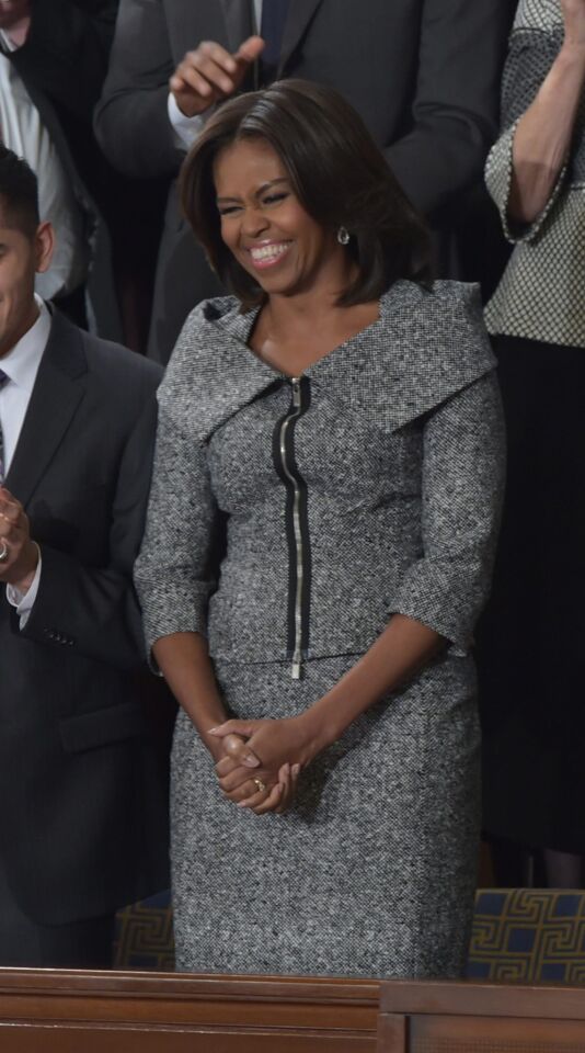 Michael Kors was one of the American designers well-represented in Michelle Obama's wardrobe. Here she attends the 2015 State of the Union address in a gray skirt suit by Kors.