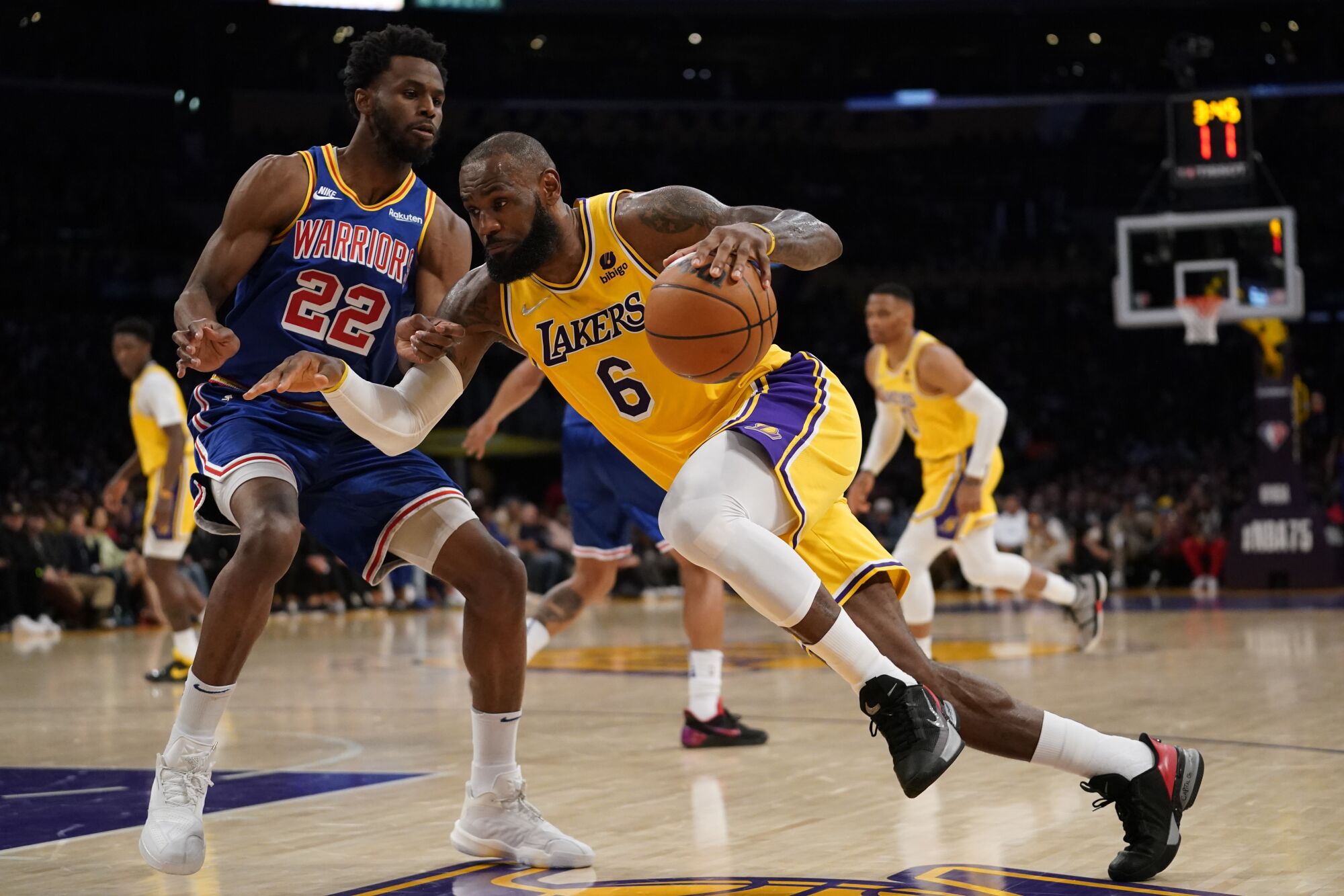 Lakers forward LeBron James drives the baseline against Warriors forward Andrew Wiggins.