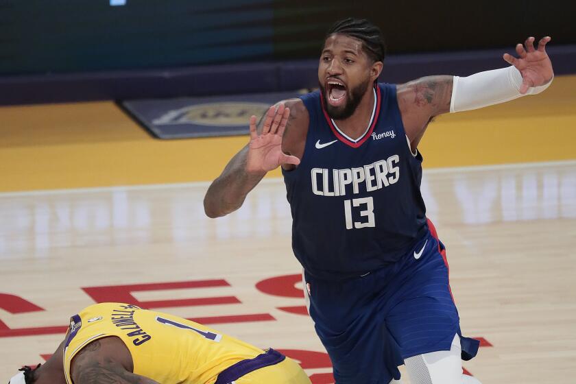 Clippers guard Paul George calls for the ball as Lakers guard Kentavious Caldwell-Pope writhes in pain.