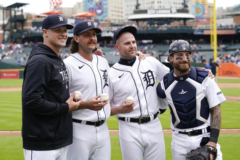 Detroit Tigers pitchers Matt Manning, from left, Jason Foley, Alex Lange, and catcher Eric Haase pose after a baseball game against the Toronto Blue Jays, Saturday, July 8, 2023, in Detroit. The three pitchers combined to no-hit the Toronto Blue Jays in a 2-0 win. (AP Photo/Paul Sancya)