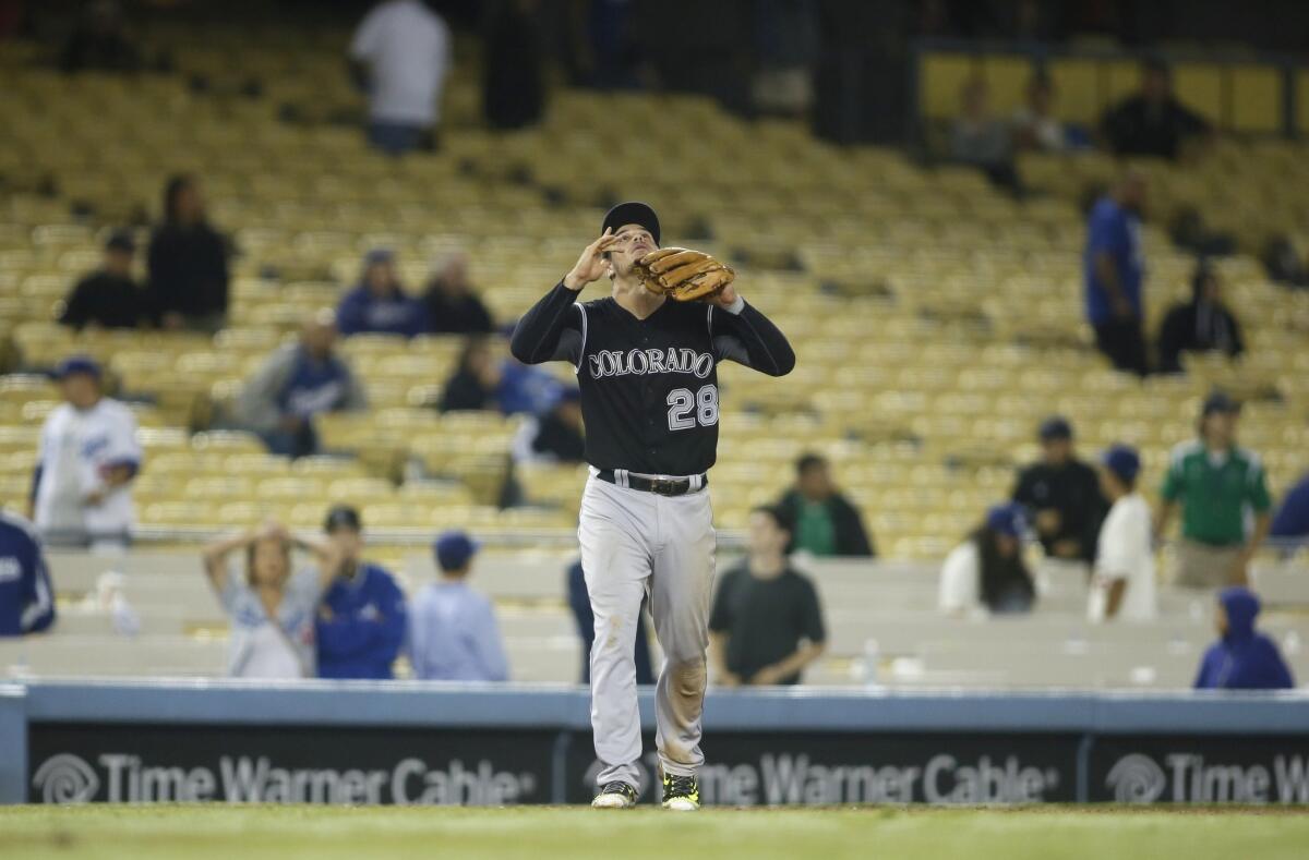 Colorado's Nolan Arenado celebrates in front of a sparse Dodger Stadium crowd after the Rockies won a 16-inning game early on Sept. 16.