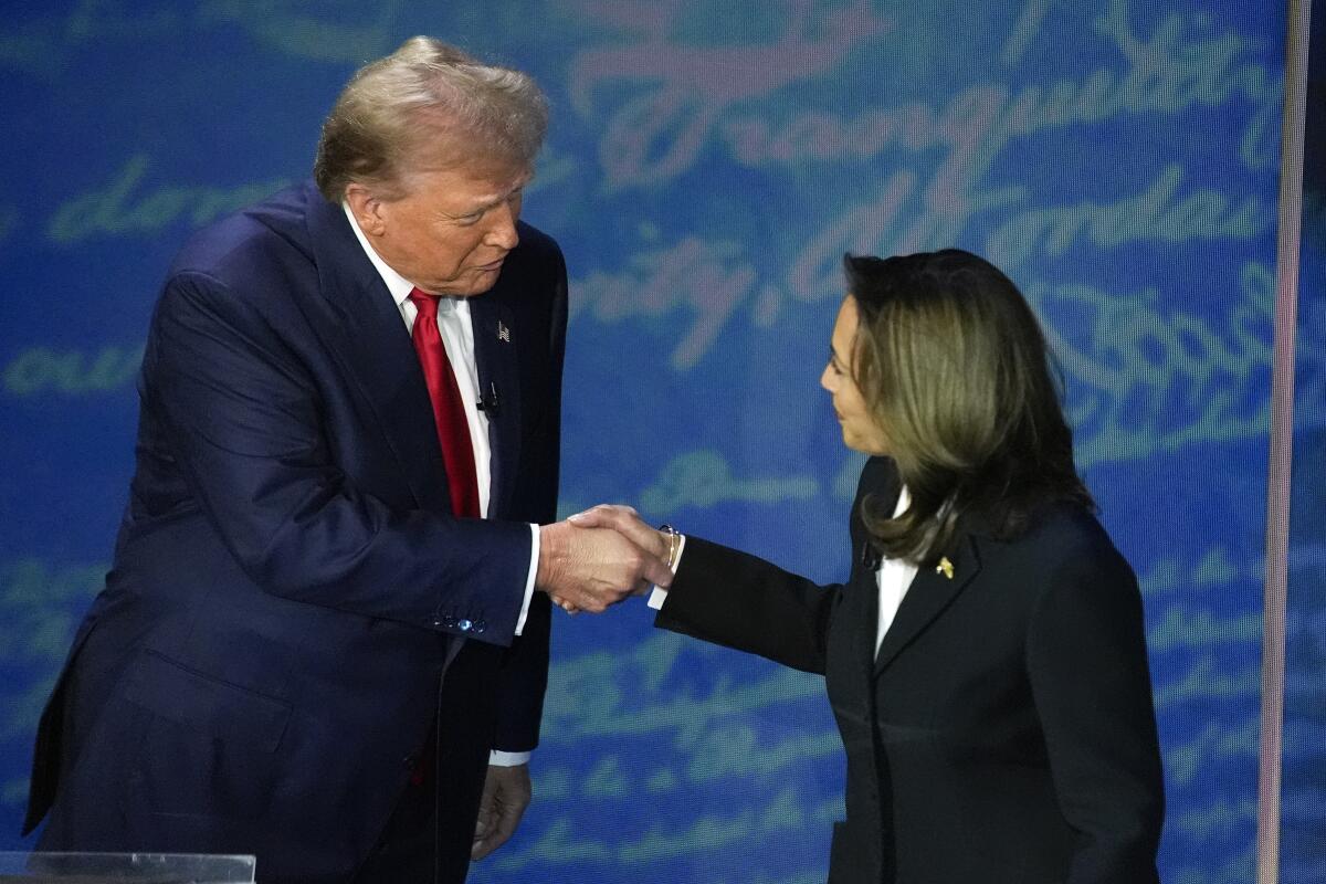 Former President Trump shakes hands with Vice President Kamala Harris at the start of a debate.