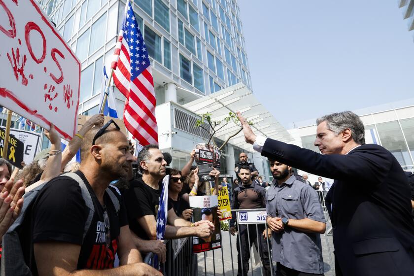 U.S. Secretary of State Antony Blinken, right, meets with the families and supporters of the hostages held by Hamas, outside of a hotel, in Tel Aviv, Israel, Wednesday, May 1, 2024. (Evelyn Hockstein/Pool Photo via AP)