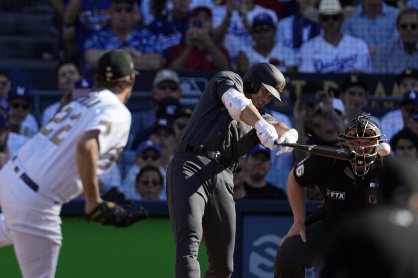 Angels star Shohei Ohtani, left, singles off Dodgers pitcher Clayton Kershaw during the first inning.