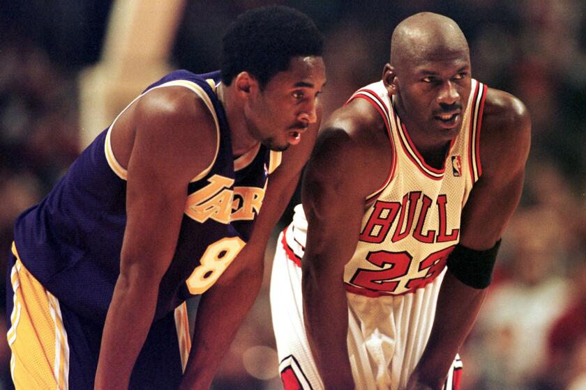 CHICAGO, UNITED STATES: Los Angeles Lakers guard Kobe Bryant(L) and Chicago Bulls guard Michael Jordan(R) talk during a free-throw attempt during the fourth quarter 17 December at the United Center in Chicago. Bryant, who is 19 and bypassed college basketball to play in the NBA, scored a team-high 33 points off the bench, and Jordan scored a team-high 36 points. The Bulls defeated the Lakers 104-83. AFP PHOTO VINCENT LAFORET (Photo credit should read VINCENT LAFORET/AFP via Getty Images)