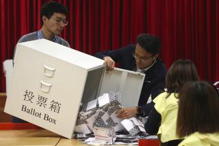 FILE - Election workers empty a ballot box to count votes for a district council election at a polling station in Hong Kong, Nov. 24, 2019. Hong Kong's leader on Tuesday, May 2, 2023, stepped up a campaign to shut down democratic challenges by unveiling plans to eliminate most directly elected seats on local district councils, the last major political representative bodies mostly chosen by the public. (AP Photo/Ng Han Guan, File)