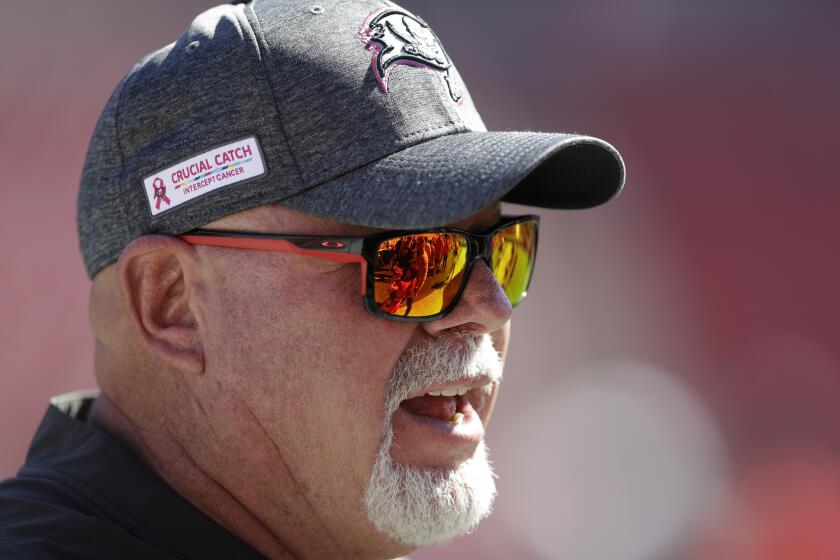 FILE - This Nov. 10, 2019, file photo shows Tampa Bay Buccaneers head coach Bruce Arians wearing a "Crucial Catch" hat before an NFL football game against the Arizona Cardinals in Tampa, Fla. The NFL is planning to allow players to have decals on the back of their helmets bearing names or initials of victims of systemic racism and police violence. The league has been in talks with individual players and their union since June about somehow honoring such victims.(AP Photo/Chris O'Meara, File)