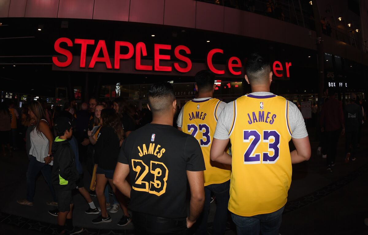 Fans line up outside of Staples Center before a Lakers game.