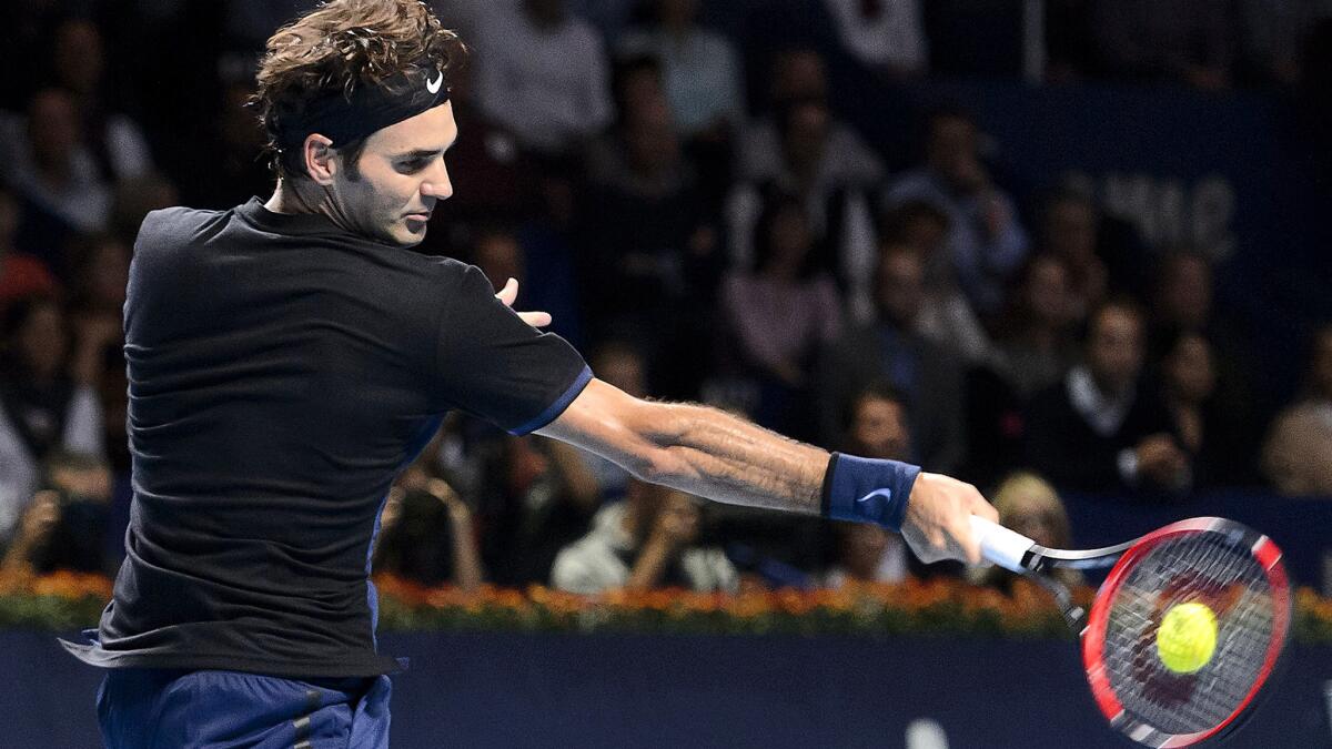 Roger Federer returns a shot against Rafael Nadal during the Swiss Indoors final on Sunday.