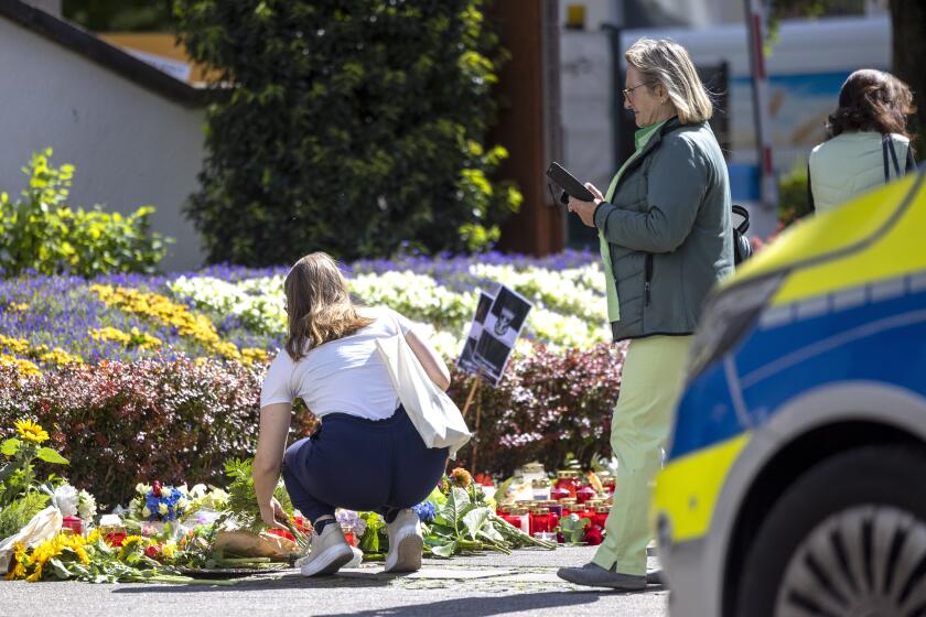 Flowers and candles are placed in Solingen, Germany, Sunday, Aug. 25, 2024, near the scene of Friday's deadly attack. (Thomas Banneyer/dpa via AP)