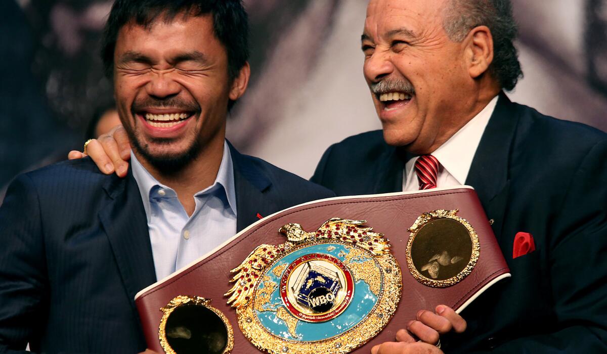 Manny Pacquiao, left, shares a lighter moment with World Boxing Organization President Francisco Varcarcel during a news conference with opponent Floyd Mayweather Jr. on April 29 at the MGM Grand Hotel in Las Vegas.