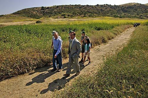 Donald Bren, chairman of the Irvine Co., left, leads Gov. Arnold Schwarzenegger and others through Bommer Canyon, part of a nearly 40,000-acre swath of Orange County open space that has been designated as the first California Natural Landmark. Photos