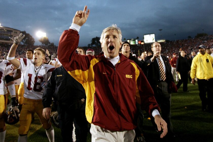 University of Southern Caifornia coach Pete Carroll celebartes with members of his team after defeating UCLA, 29-24, at the Rose Bowl in Pasadena, Calif., Saturday, Dec. 4, 2004. (AP Photo/Kevork Djansezian) ORG XMIT: PRB106