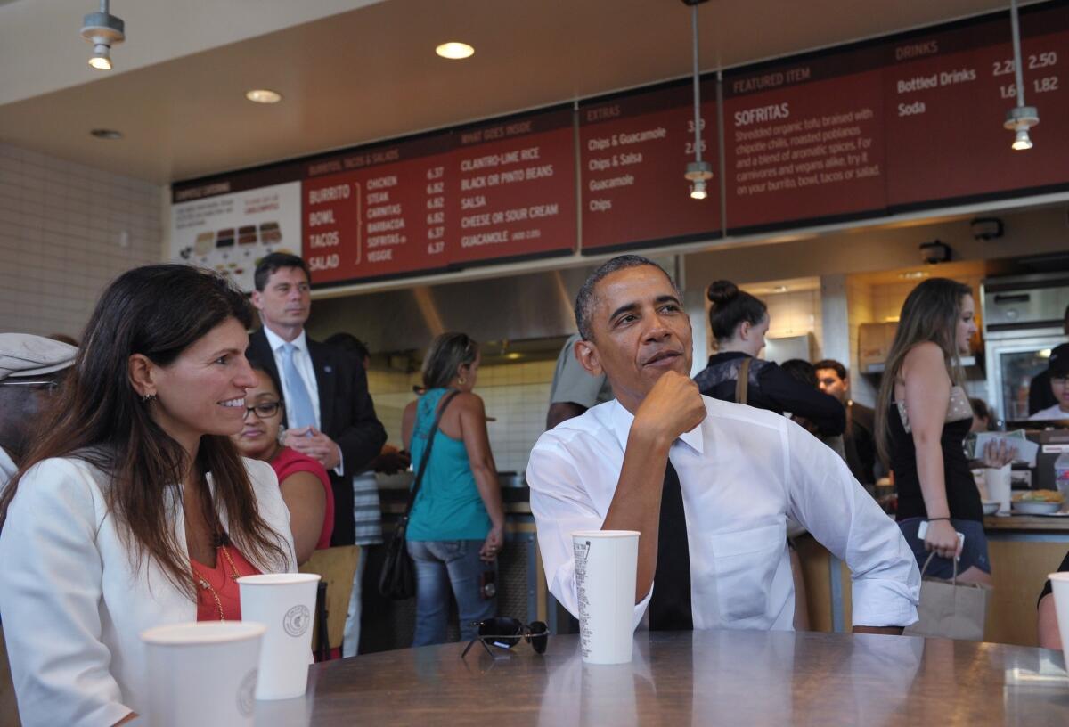 President Barack Obama stops for lunch at a Chipotle Mexican Grill restaurant on June 23, 2014 in Washington. A photo of Obama reaching over the sneeze guard while ordering went viral on Twitter.